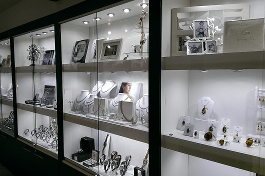 Glass Sliding Doors With Locks Display Case With Glass Sliding Doors And Locks Showcasing Jewelry And Framed Photographs.