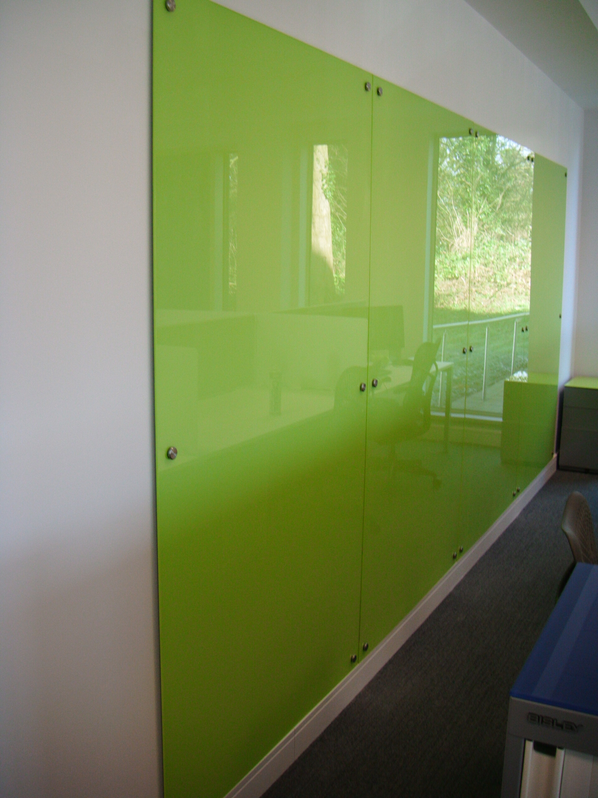 Green Glass Backsplash Feature Wall In A Modern Office Interior.