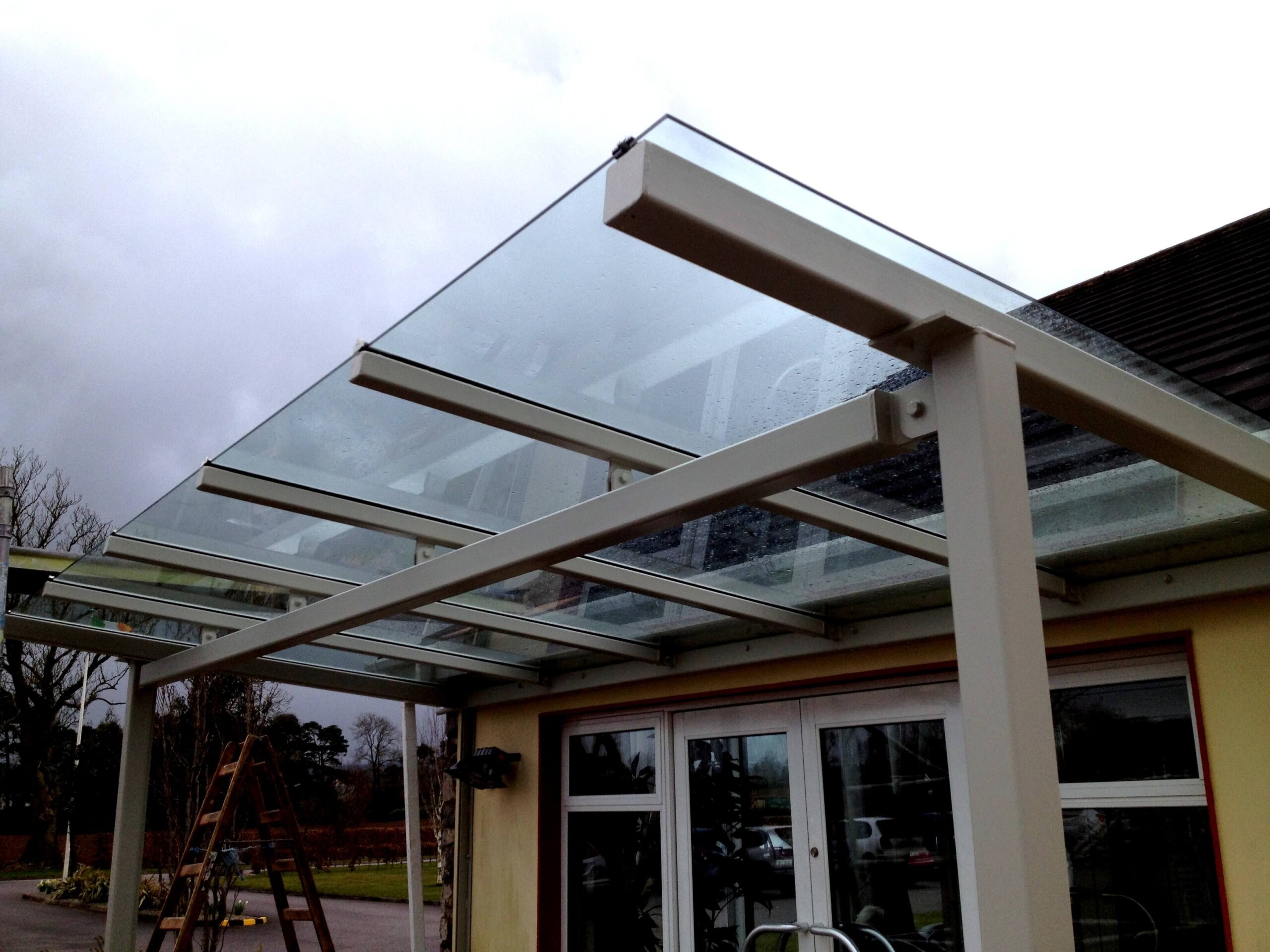 Laminated Safety Glass Roofing Supported By White Beams