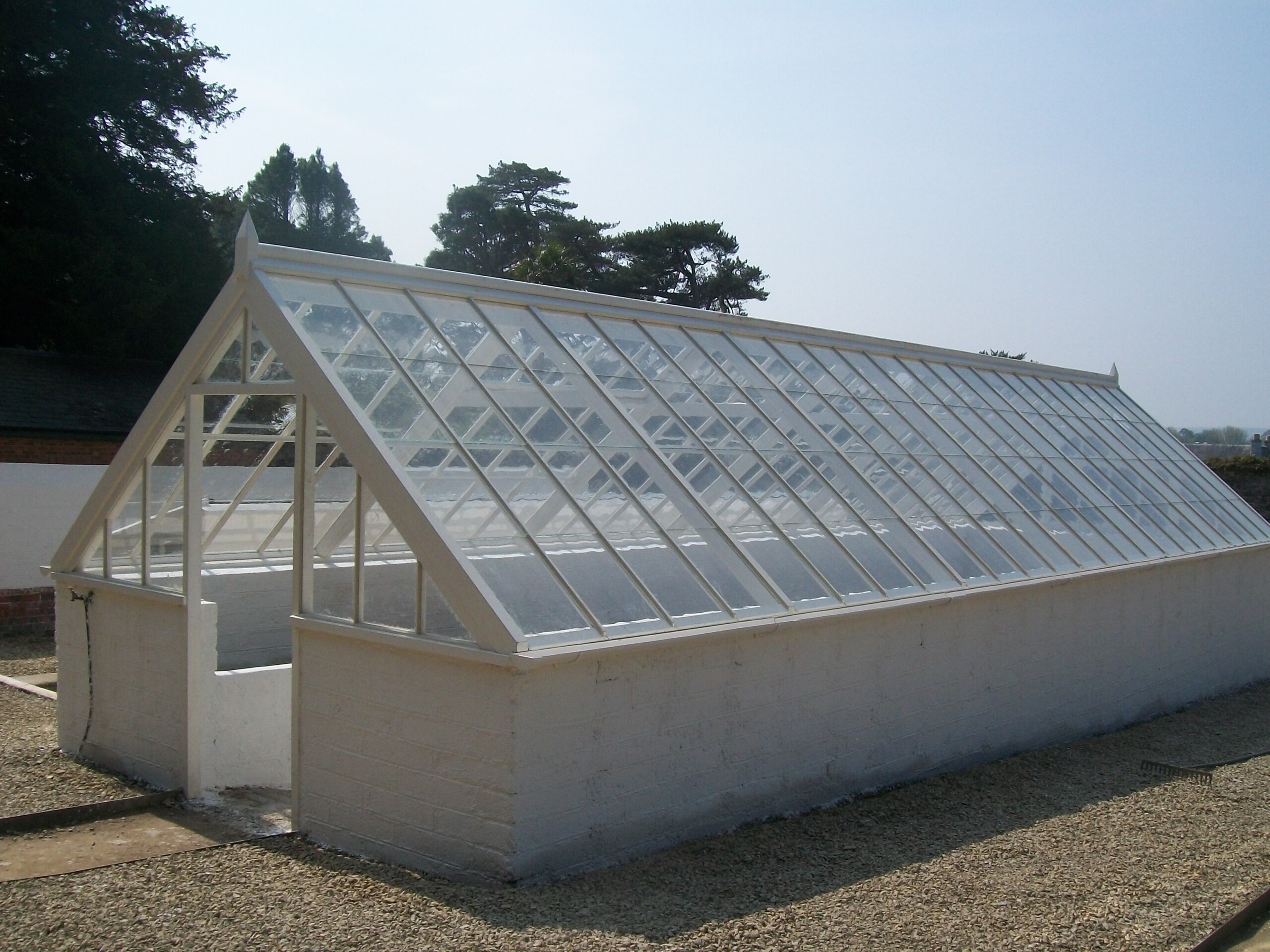 Large Greenhouse Glass Panels Large Outdoor Glass Greenhouse With White Base And Triangular Roof