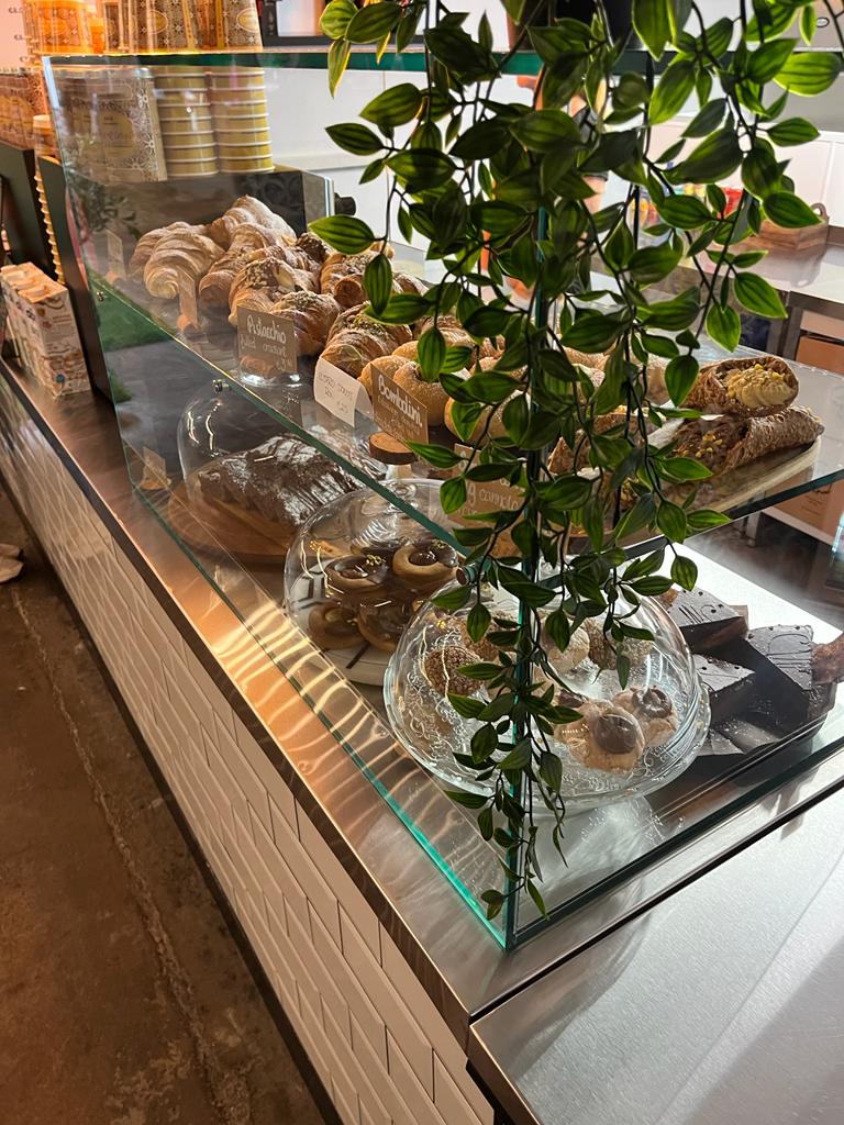 Glass Case Northside Glass Ltd. Supplied A Commercial Curved Glass Display Case For A Cafe Counter, Featuring Baked Goods And Internal Plants In Cork, Ireland.