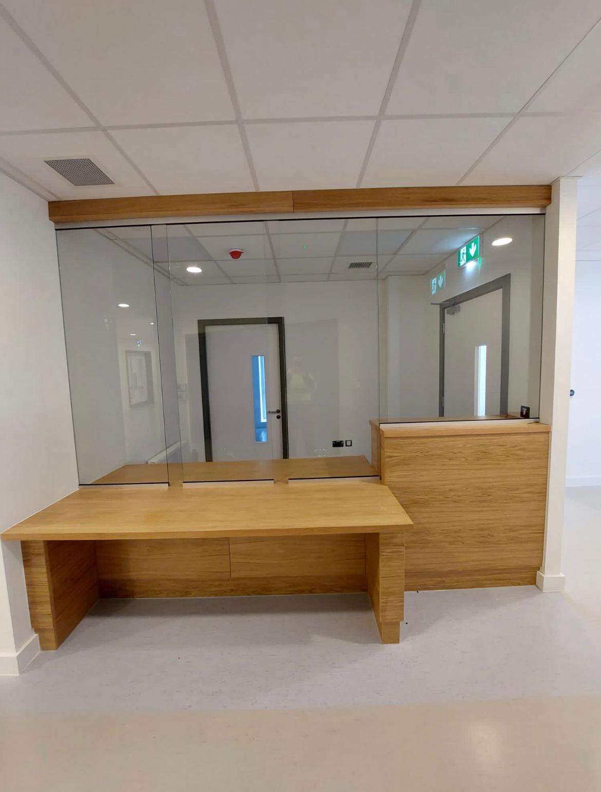 Glazed Security On Reception Desk Screen Wooden Reception Desk With Glazed Security Screen And Hallway Background