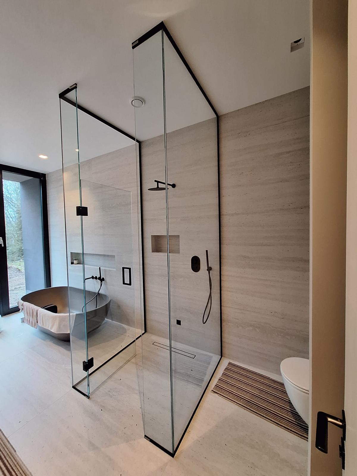 Shower Enclosure Black Trim Walk-In Shower Enclosure With Black Trim And Clear Glass Panels In A Modern Bathroom With A Freestanding Tub.